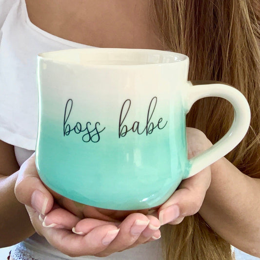 Woman holding an ombre mint green mug with gold bottom that says "Boss Babe"